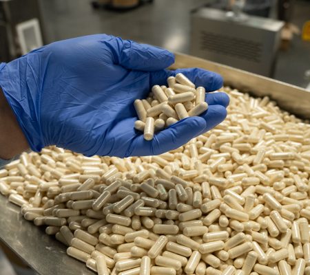 Empty supplement capsules on a stainless steel surface